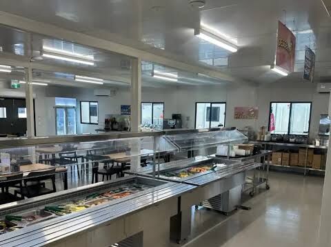 Servery counters and dining area in a remote-site kitchen and dining facility