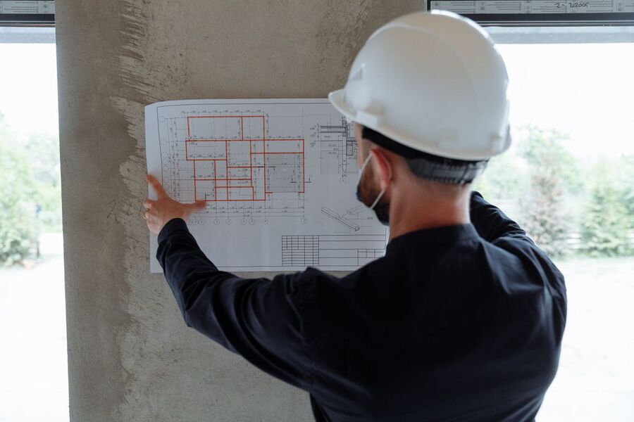 Project engineer reviewing construction plans on site